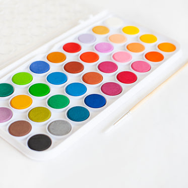 brand new watercolor set on white table