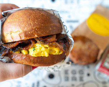 breakfast sandwich in hand