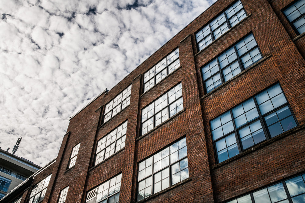 brick building under clouds