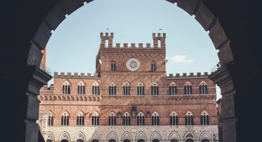 brick castle framed in an archway