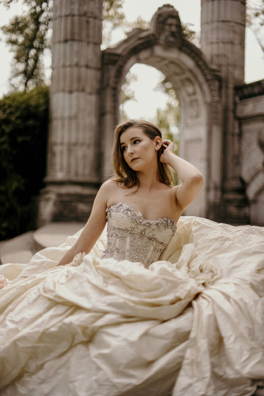 bride adjusts hair wedding photography