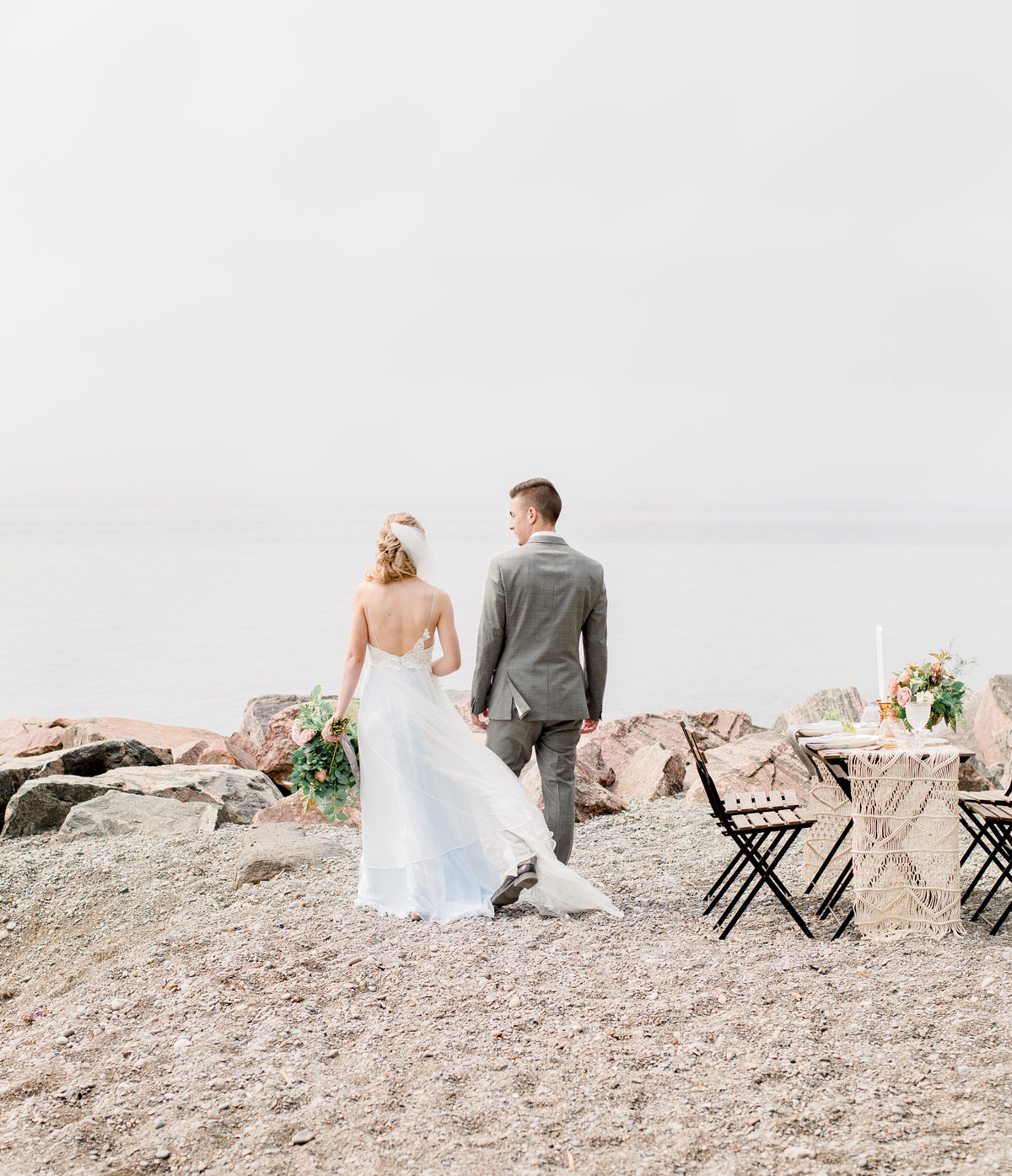 bride and groom walk the beach