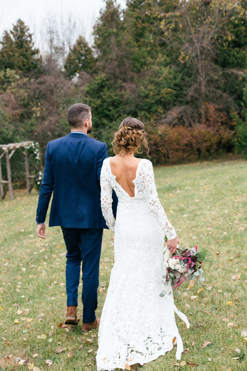 bride and groom walking on the grass