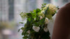 bride clasps her bouquet