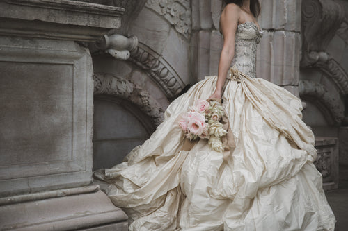 bride holding flower in ruins