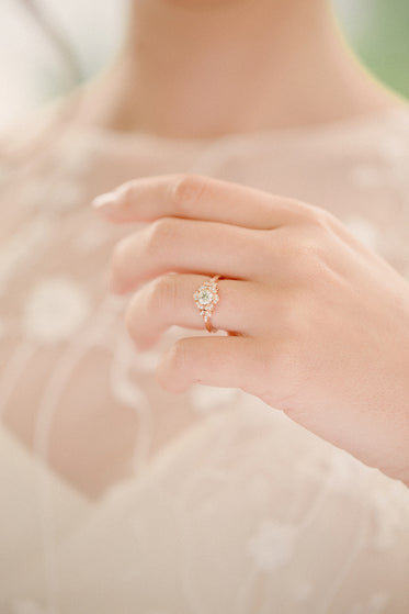 bride holds up wedding ring