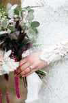 bride in wedding dress holding her wedding bouquet