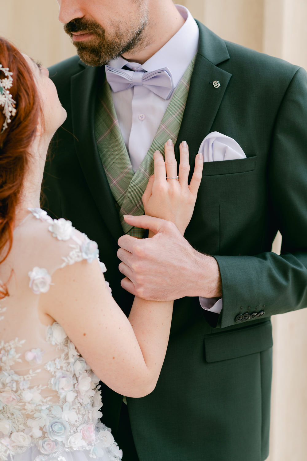 bride places hands on the groom and looks up