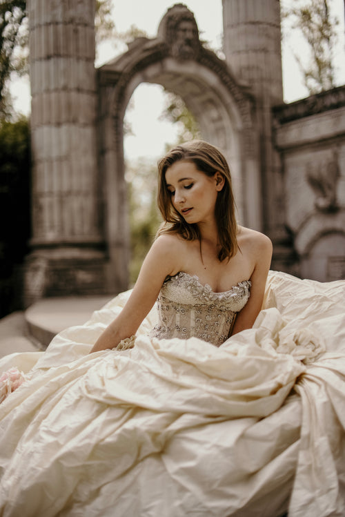 bride sits in flowing wedding dress