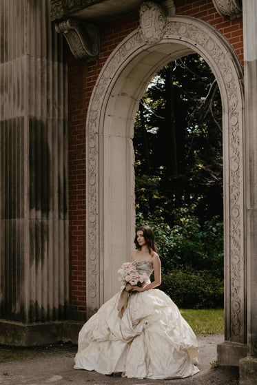 bride walks down aisle through archway