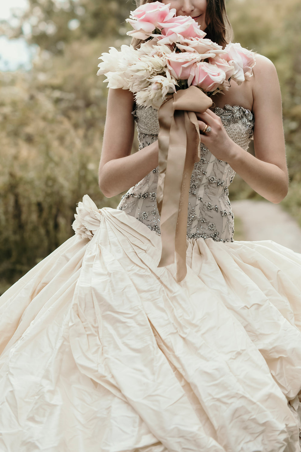 bride with pink wedding bouquet