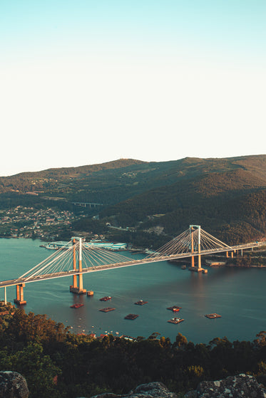 bridge connecting two green mountains