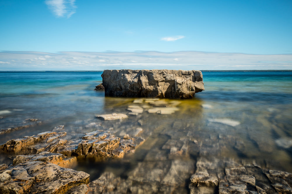 bright blue day water rock