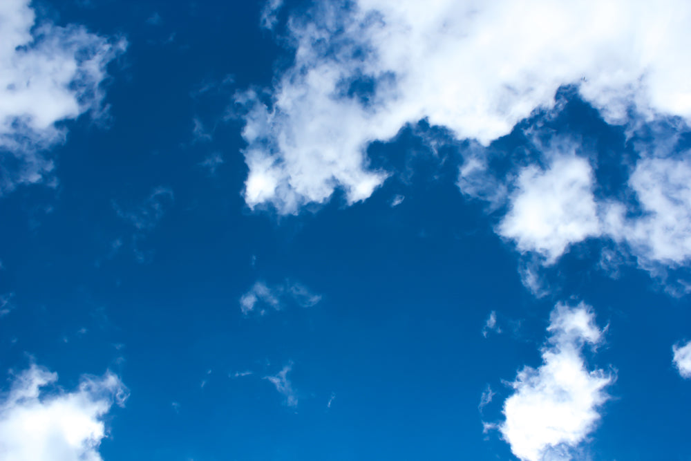 bright blue sky dotted with fluffy white clouds