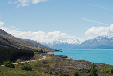 bright blue water and mountain side highway