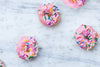 bright pink donuts with sprinkles