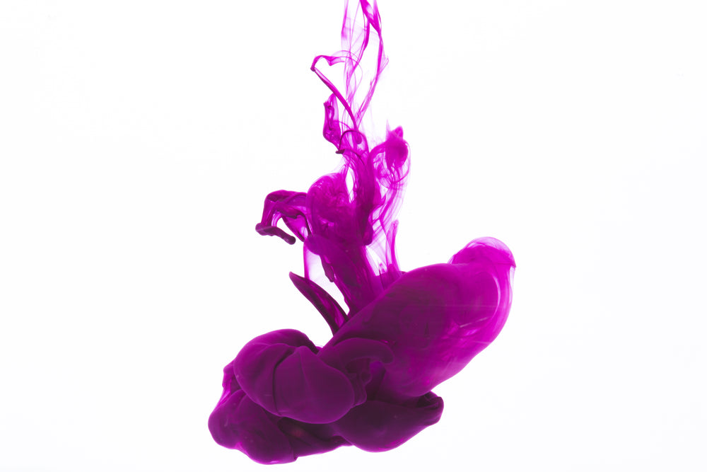 bright purple ink drop on white