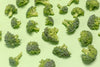 broccoli pieces on green surface