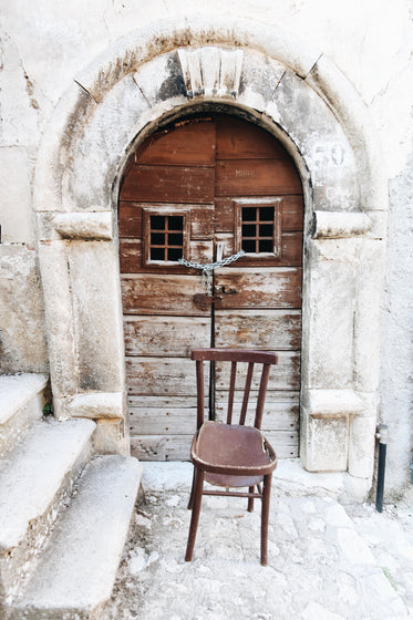 broken chair before locked doors