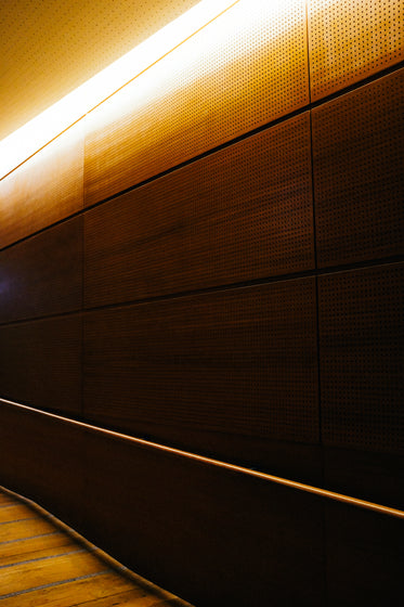 brown wall lit up with a yellow light at top