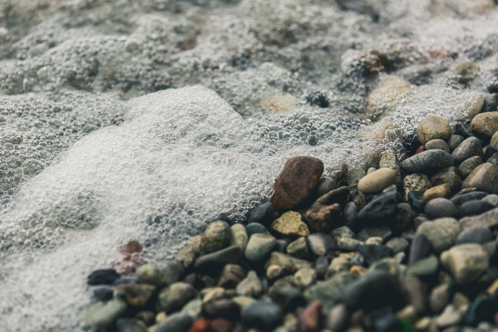 bubbly water on rocky shore