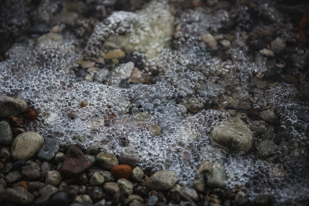 bubbly water on stoney shore