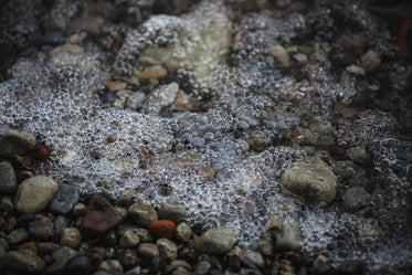 bubbly water on stoney shore