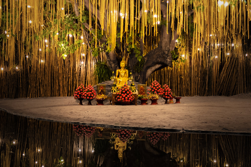 buddhist statues surrounded by flowers