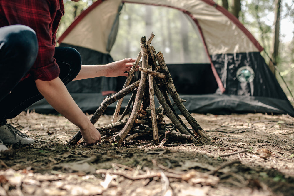 building a fire in front of tent