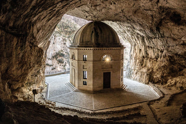 building in a cave with a stone walkway