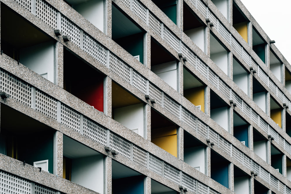 building on an angle with colorful balcony walls