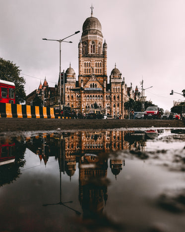 building reflected in puddle