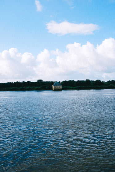 building sinking into blue water