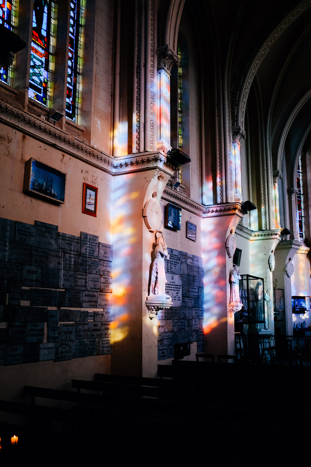 building wall with colorful light from stained glass