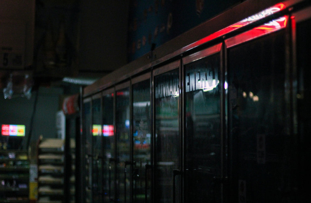 building with large glass windows lit by city lights