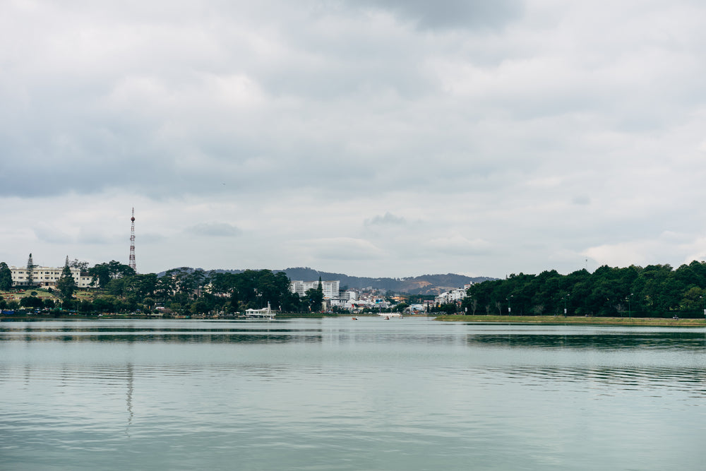 buildings line lake side with mountains