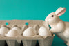 bunny statue watches eggs