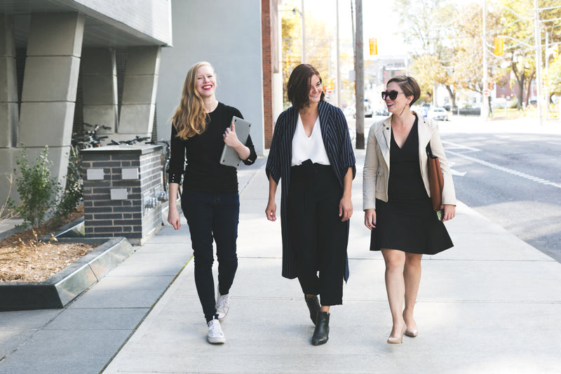 Professionals walking through a city street at pace