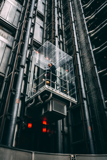 businessman in glass elevator going up