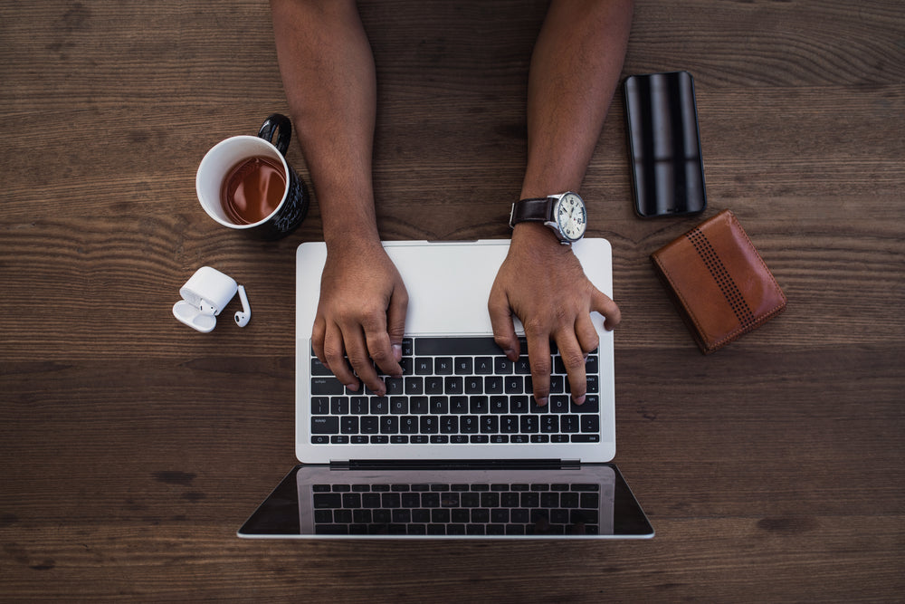 busy hands typing in flatlay