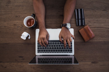 busy hands typing in flatlay