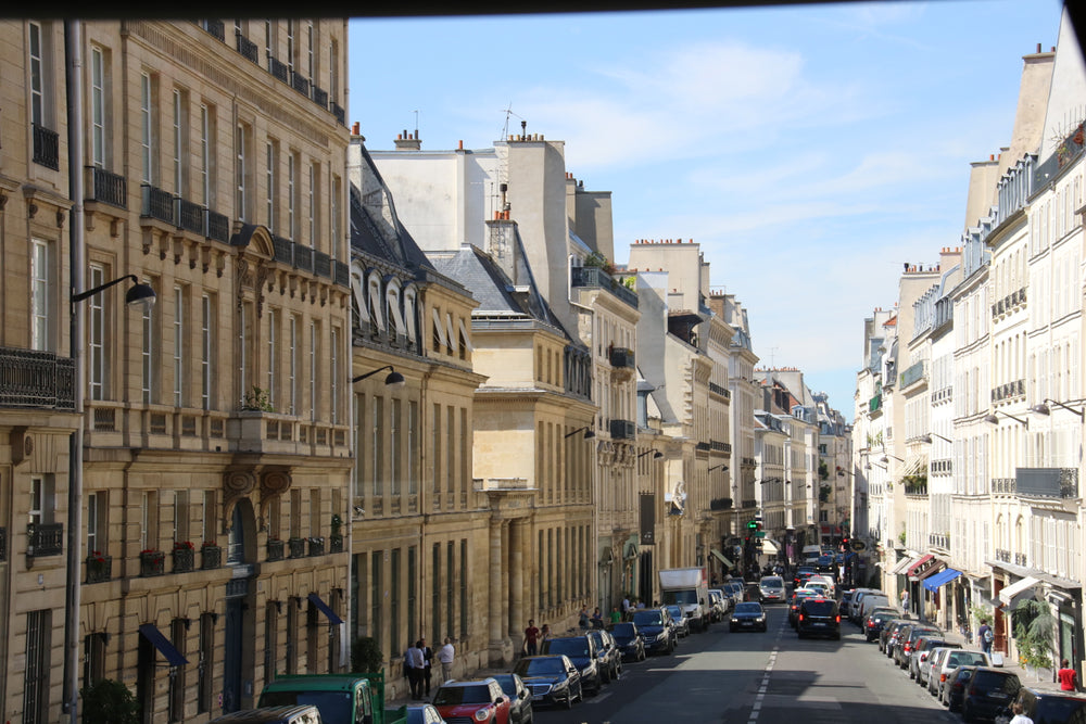 busy street lined with cars and white buildings