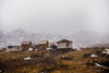 cabins on a brown hill with soft falling snow