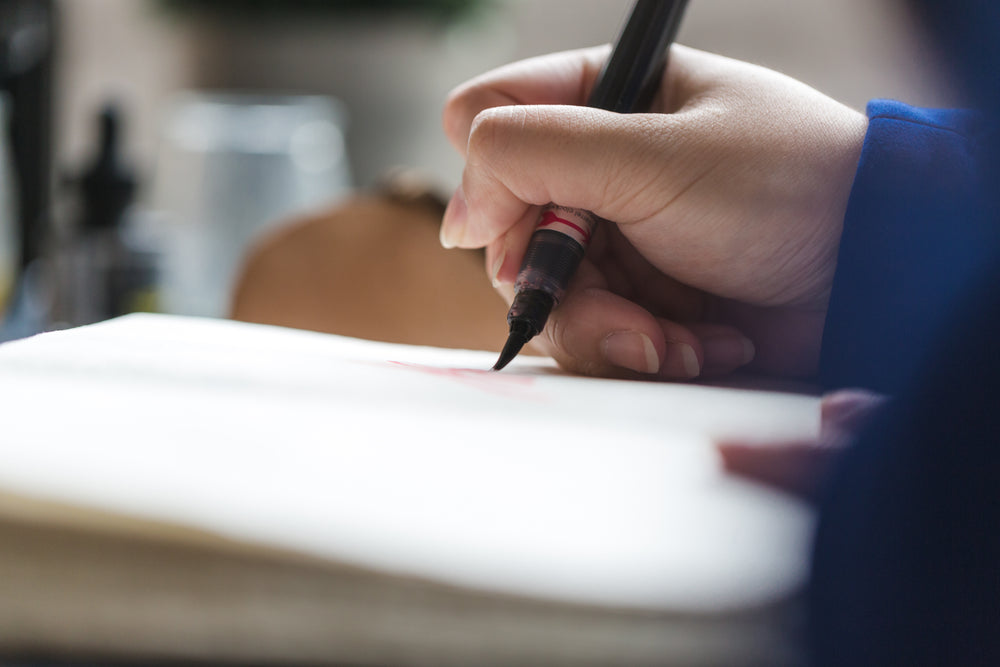 calligraphy artist writing with pen