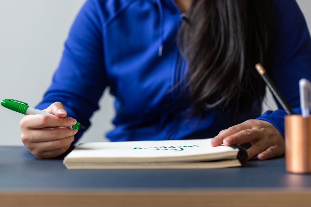 calligraphy writing in notebook