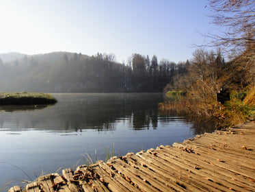 calm lake by rustic boardwalk