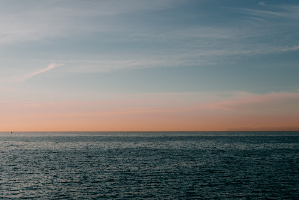 calm pacific ocean at sunset off california coastline