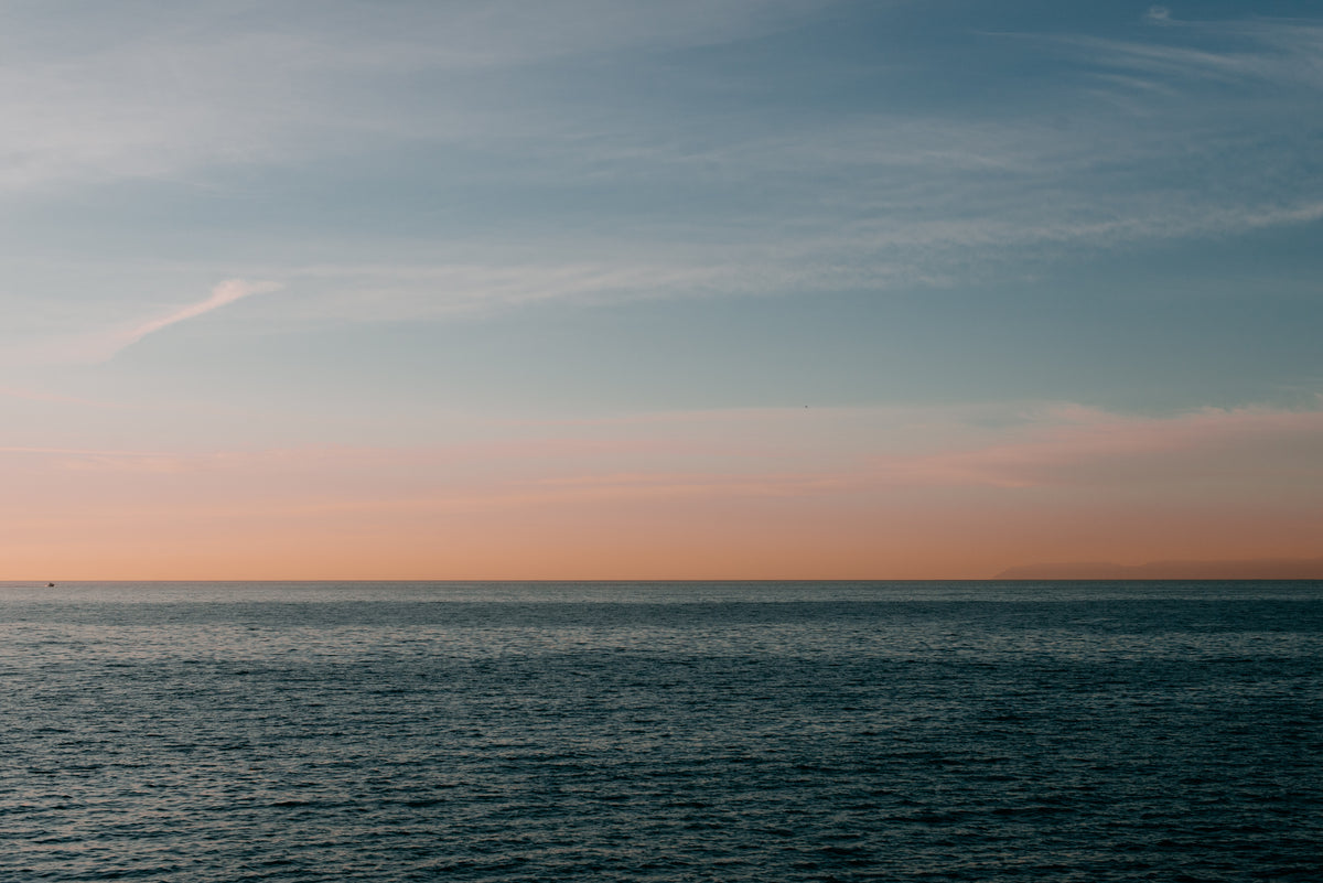 calm pacific ocean at sunset off california coastline