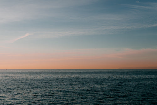 calm pacific ocean at sunset off california coastline