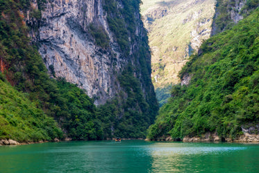 calm water beneath an expanse of green mountains